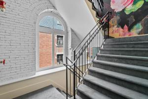 a staircase with a window and a brick wall at Arcadia Hotel Boutique in Montreal +57 photos