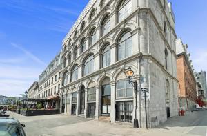 a large stone building on a city street at Arcadia Hotel Boutique in Montreal