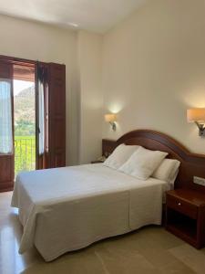 Ένα ή περισσότερα κρεβάτια σε δωμάτιο στο Hotel San Sebastián Hospedería