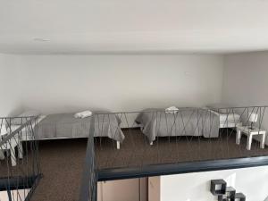 a room with two beds and a table at Jégmadár Vendégház in Baja