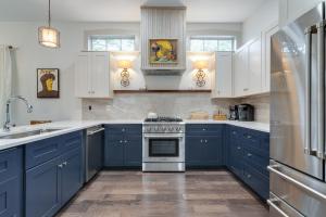 a kitchen with blue cabinets and a stove at Higbee House Too, AKA The Jolly Roger in Memphis