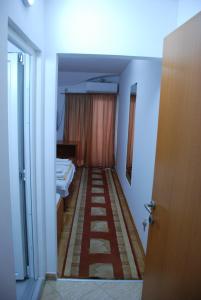 a room with a hallway with beds and a door at Villa LD in Skopje