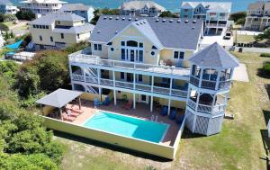an aerial view of a large house with a swimming pool at Semi-Oceanfront, Priv Pool, Hot Tub, ELEV, Rec Rm-WL980, OBX Beach Bliss in Corolla