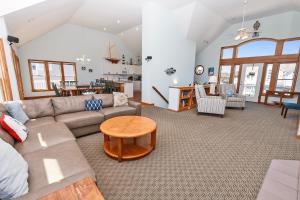 a living room with a couch and a table at Semi-Oceanfront, Priv Pool, Hot Tub, ELEV, Rec Rm-WL980, OBX Beach Bliss in Corolla