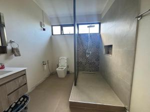 a bathroom with a shower and a toilet at Seaview escape - modern & cozy in Baie du Cap +7 photos