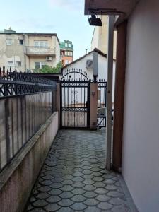 a gate to a building with a stone walkway at Villa LD in Skopje