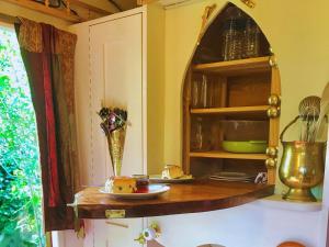a kitchen with a table with a plate of food at The Gypsy Knot in Wells next the Sea