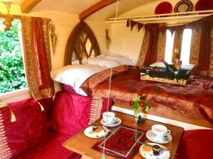 a train room with a bed and a table with food at The Gypsy Knot in Wells next the Sea