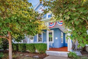 a blue house with american flags on it at Historic 3 BR Home - 15 Min Walk to N-MC Stadium in Annapolis