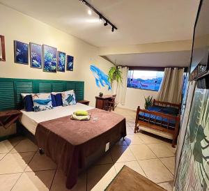 a bedroom with a large bed and a window at Chamos Hostel Cultural in Arraial do Cabo +64 photos
