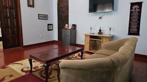 a living room with a couch and a coffee table at Buladde Palm Villa Hotel in Kampala