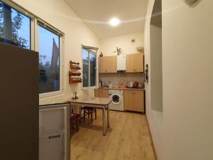 a small kitchen with a table and a tableablish at Певчая птица in Dilijan