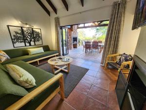 a living room with a couch and a table at Kensington Lodge Golf Estate Villa - 17 Pinehurst Drive in White River