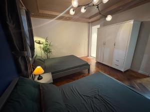 a living room with a bed and a cabinet at Hoshi Dalat Fullhouse in Xuan An