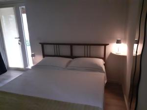 a bedroom with a bed with two pillows and a lamp at B&B Al Castagneto in Valmontone