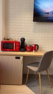 a red microwave sitting on top of a table at Heights Accommodation Old Center in Bucharest