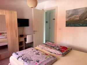 a room with two beds and a mirror at Apartman VIVA in Bihać