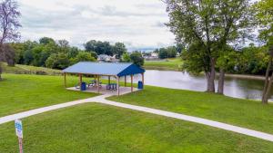 a gazebo in a park next to a river at Dry Ridge Village - 3 Houses - Close to Ark- Hot Tubs in Dry Ridge