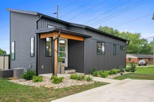a house with black siding at Dry Ridge Village - 3 Houses - Close to Ark- Hot Tubs in Dry Ridge