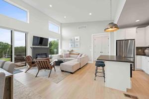 a kitchen and living room with a table and chairs at Dry Ridge Village - 3 Houses - Close to Ark- Hot Tubs in Dry Ridge +44 photos