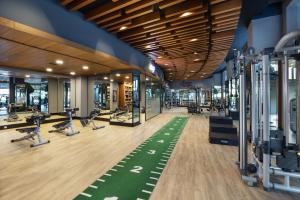 a gym with treadmills and exercise equipment in a building at Titanic Luxury Collection Bodrum in Guvercinlik
