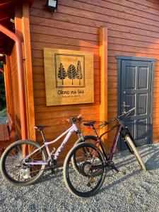 two bikes parked in front of a building at Okno na las in Polanica-Zdrój