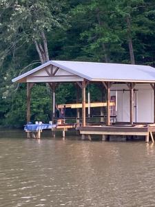 a gazebo on a dock in the water at Lakeside Lodge on Bluegill- Arcade, Dock, FirePit in Eatonton