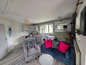 a living room with a couch and a chair at Beautiful small home in Mallow