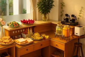 a breakfast table with cheese and other foods on it at Phan Anh Hotel - Bui Vien Walking Street in Ho Chi Minh City