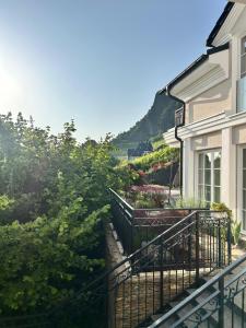 a house with a fence and flowers on the side of it at Rheintal Luxusresidenz in Röhndorf in Bad Honnef am Rhein