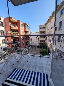 a balcony with a swing and a table and chairs at Podslon Varna Vibes in Varna City
