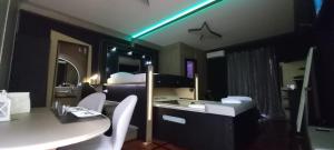 a small room with a bed and a table and chairs at Boutique Roma D'Autore - Il Nido d'Amore in Rome