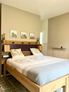 a bedroom with a large bed in a room at Le clos mirélie in Gaujac +31 photos