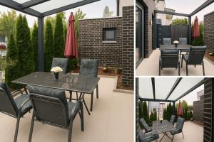 a patio with a table and chairs and a brick wall at Ferienapartment Münster in Münster