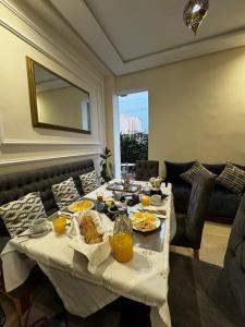 a table with food and drinks on it in a living room at Dar Diaft'na in Marrakesh