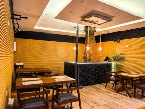 a dining room with wooden tables and chairs at Sky Garden Kandy in Kandy