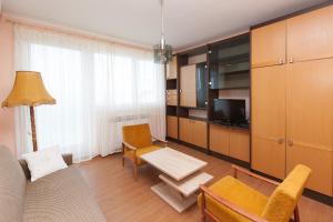 a living room with a couch a table and a tv at Apartment Anne in Crikvenica
