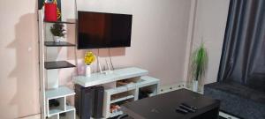 a living room with a tv on a wall at Flex Zone in Nairobi