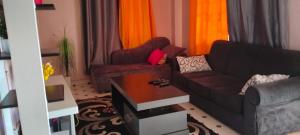 a living room with a couch and a table at Flex Zone in Nairobi