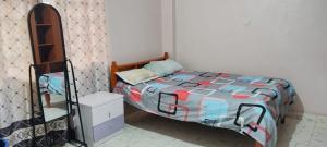 a small bedroom with a bed and a mirror at Flex Zone in Nairobi