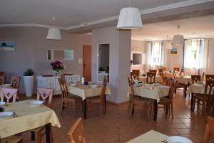 a dining room with tables and chairs and tablesktop at Kalmar in Darlowko