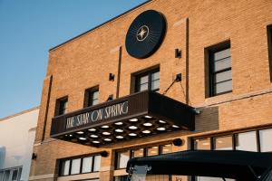 a building with a clock on the side of it at The Star on Spring in Springdale