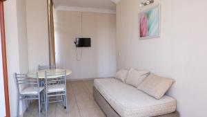 a living room with a couch and a table and chairs at İSABELLA APART OTEL in Alanya