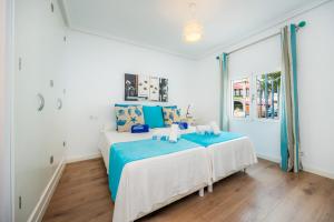a bedroom with two beds and a window at La Casita in Pollença