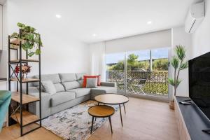 a living room with a couch and a table at Sunny Stays Espinho - Balcony & Pool in Espinho