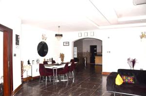 a dining room with a table and red chairs at Chic Modern Getaway in Freetown