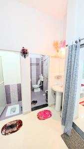 a bathroom with a toilet and a sink at Krishnaalay Guest House in Ujjain +54 photos