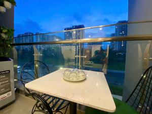 a table on a balcony with a view of a city at Vinhome grandpark q9 in Gò Công