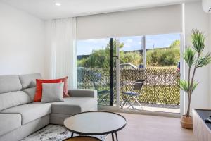 a living room with a couch and a table at Sunny Stays Espinho - Balcony & Pool in Espinho
