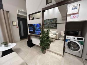 a living room with a washing machine and a couch at ANAVASI Loft SUITE in Alexandroupoli